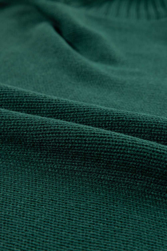 Macro shot of green acrylic knit fabric from the Stylish High Neck Red Sweater - Christmas, showing soft texture and tight weave.