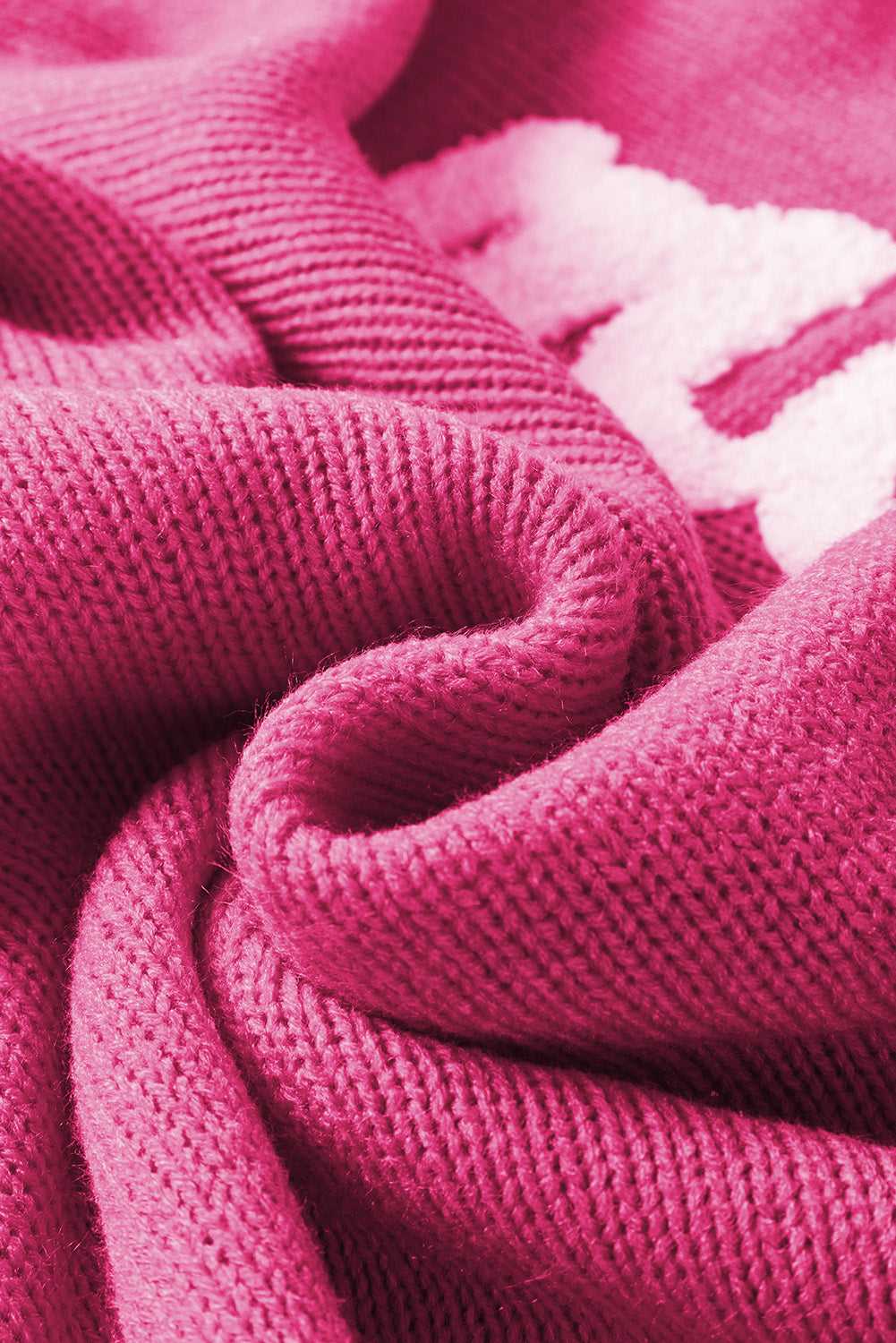 Close-up of fiery red acrylic knit fabric from the Stylish High Neck Red Sweater - Christmas, showcasing soft texture and embroidery detail.