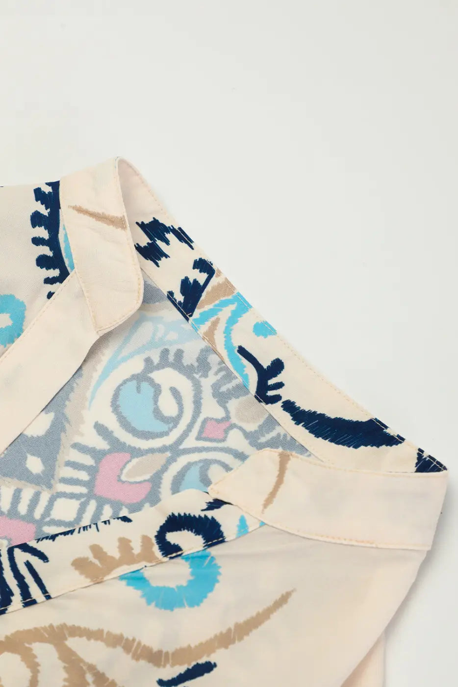 Close-up of the neckline on the Tribal Mini Dress, showing detailed stitching and vibrant boho print on soft fabric.