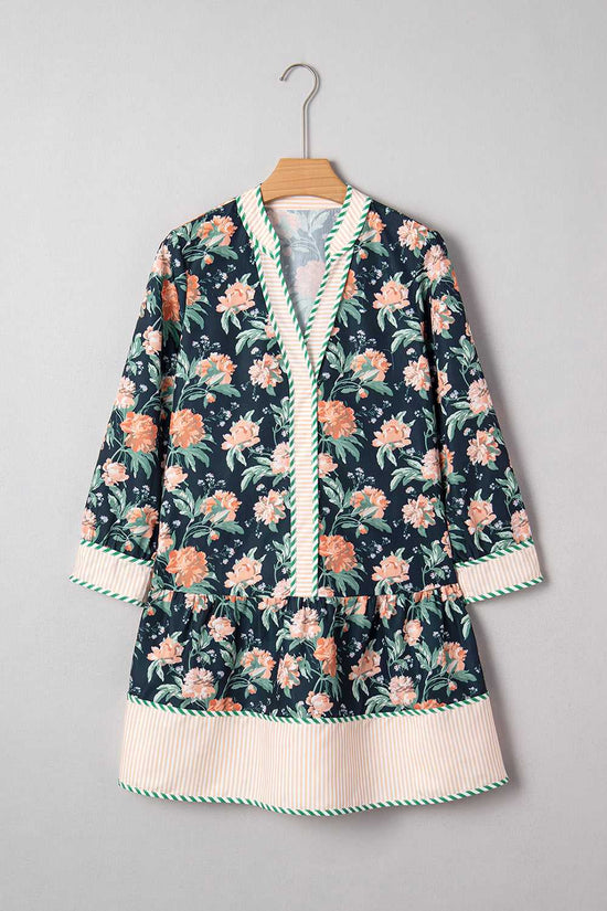 Ladies Blue Floral Shift Mini Dress on hanger, highlighting floral print, striped hem, and relaxed silhouette for springtime casual wear.