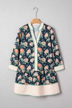 Ladies Blue Floral Shift Mini Dress on hanger, highlighting floral print, striped hem, and relaxed silhouette for springtime casual wear.