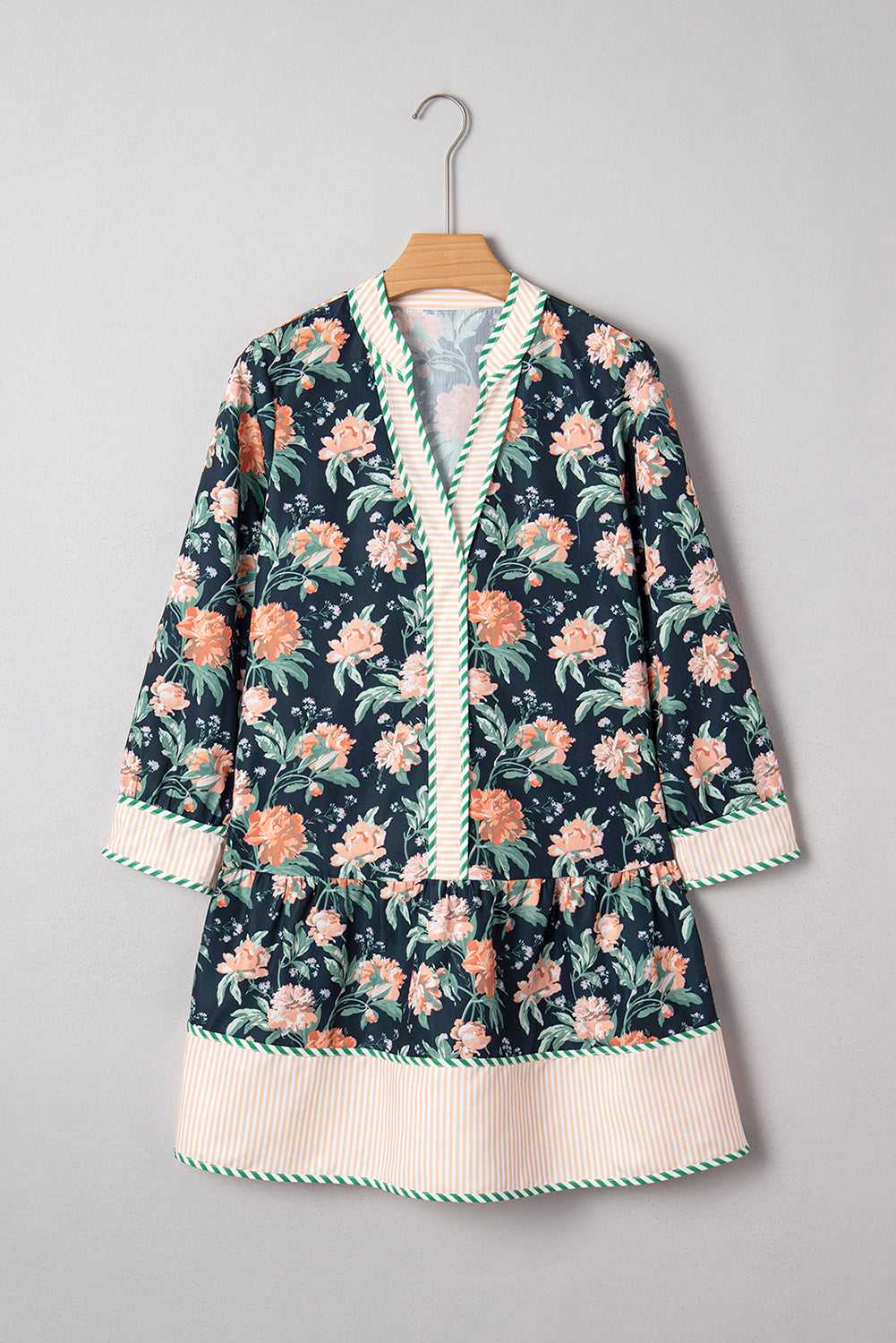 Ladies Blue Floral Shift Mini Dress on hanger, highlighting floral print, striped hem, and relaxed silhouette for springtime casual wear.