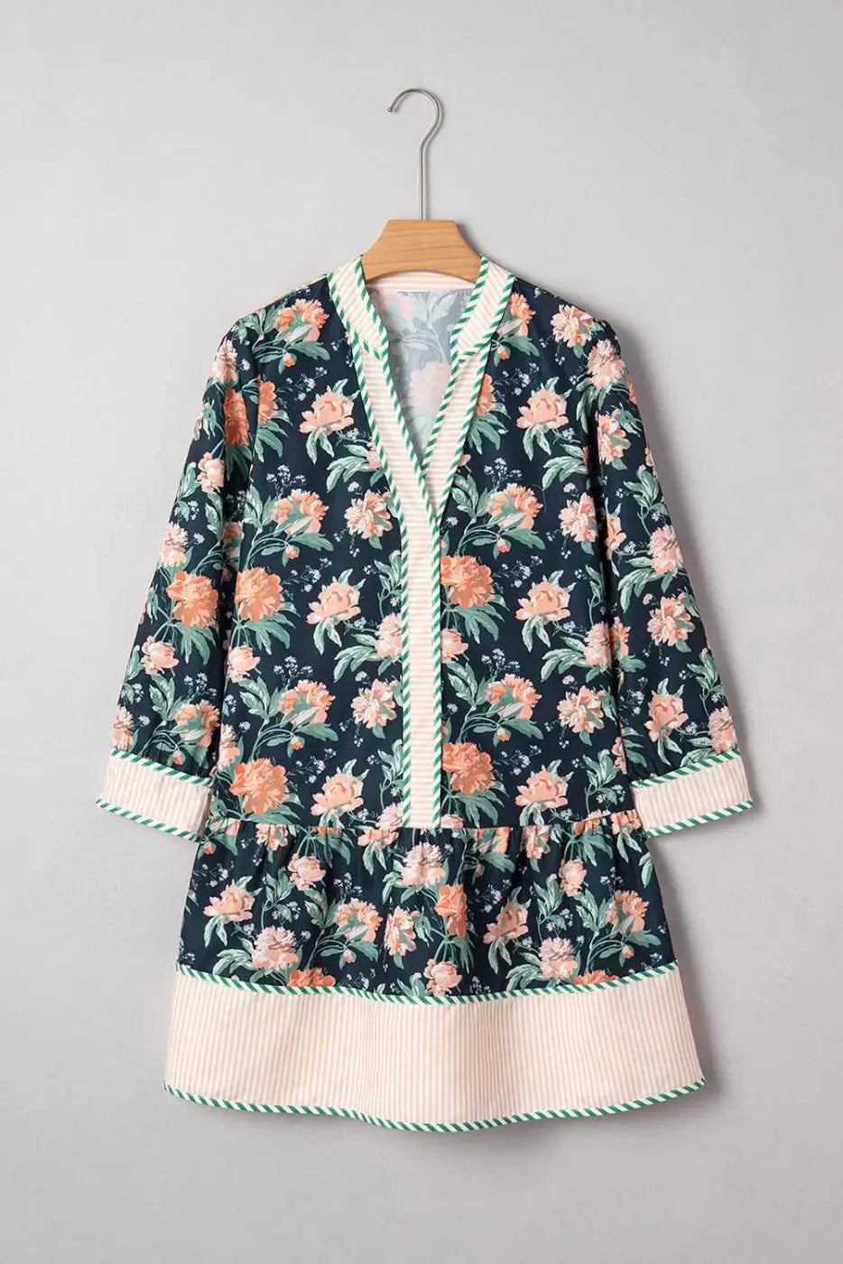 Ladies Blue Floral Shift Mini Dress on hanger, highlighting floral print, striped hem, and relaxed silhouette for springtime casual wear.