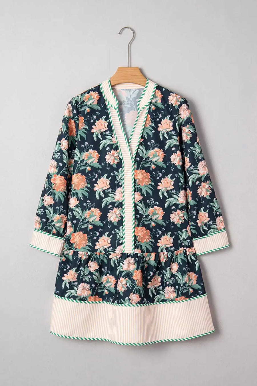 Ladies Blue Floral Shift Mini Dress on hanger, highlighting floral print, striped hem, and relaxed silhouette for springtime casual wear.
