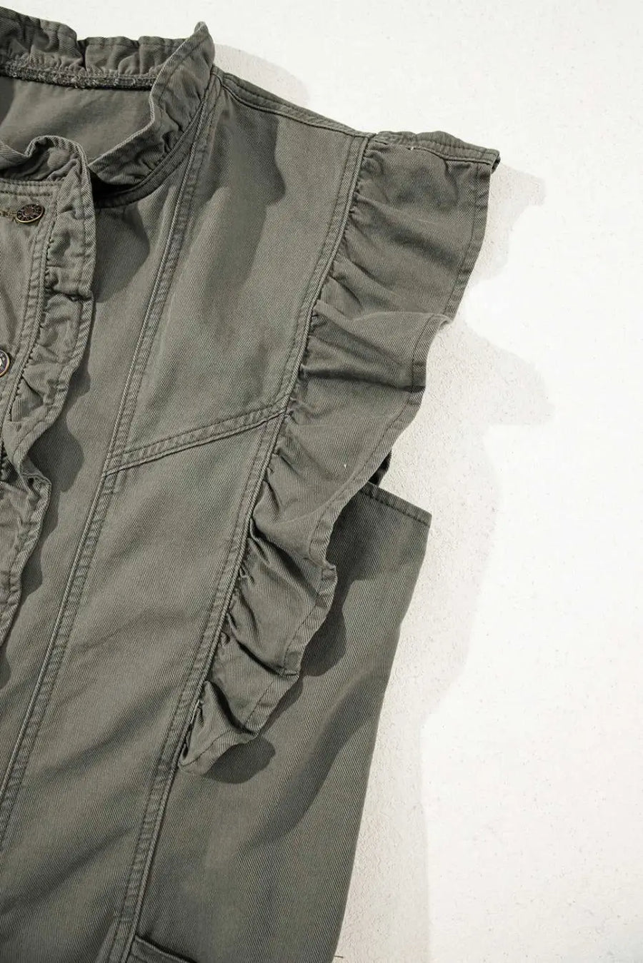 Shoulder ruffle detail on Green Bay Ruffled Denim Vest - Women's Fashion Trends showcasing feminine design in solid green denim.