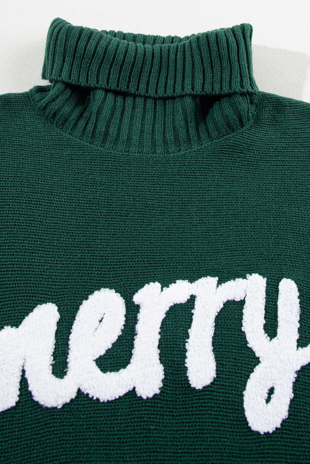 Close-up of ribbed high neck and 'merry' embroidery on green Stylish High Neck Red Sweater - Christmas, made from soft acrylic knit.