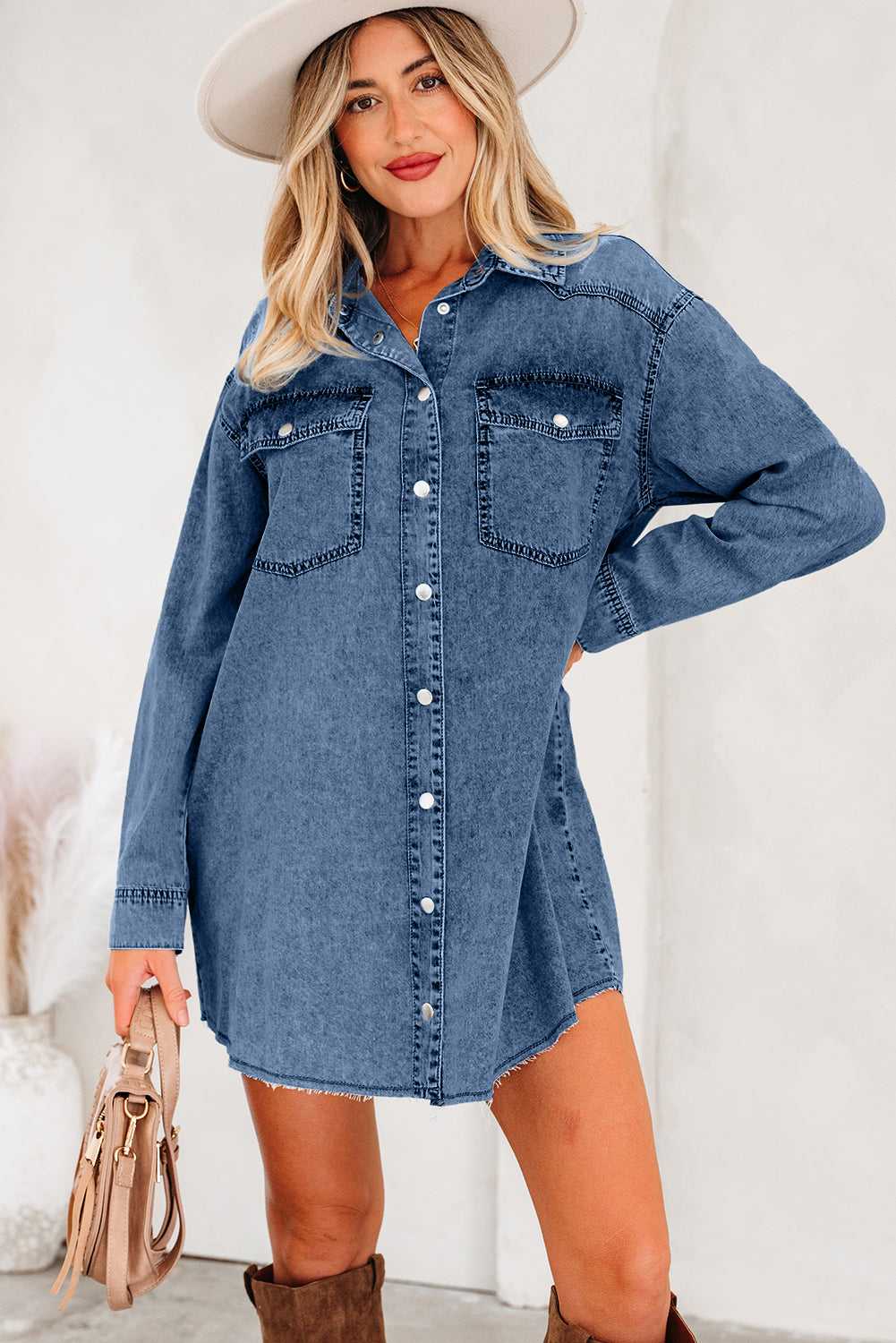 Casual raw hem oversized denim dress for women in medium blue, styled with long sleeves, front buttons, and dual chest pockets for a laid-back look.