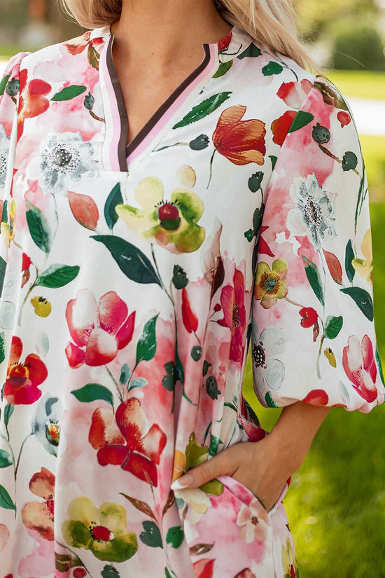Close-up of Floral Shift Dress - Casual Elegance neckline and pocket, showing contrast trim and vivid floral pattern.