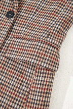 Close-up of front pocket and sleeve on Ladies Brown Houndstooth Fitted Blazer, highlighting structured tailoring and pattern.