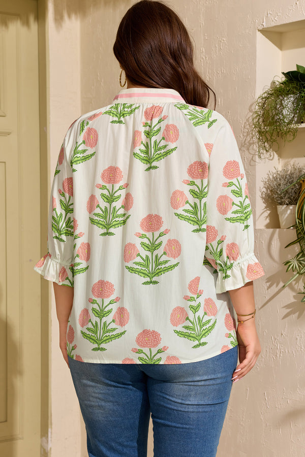 Pink floral plus size blouse — side view showing V-neck and striped trim