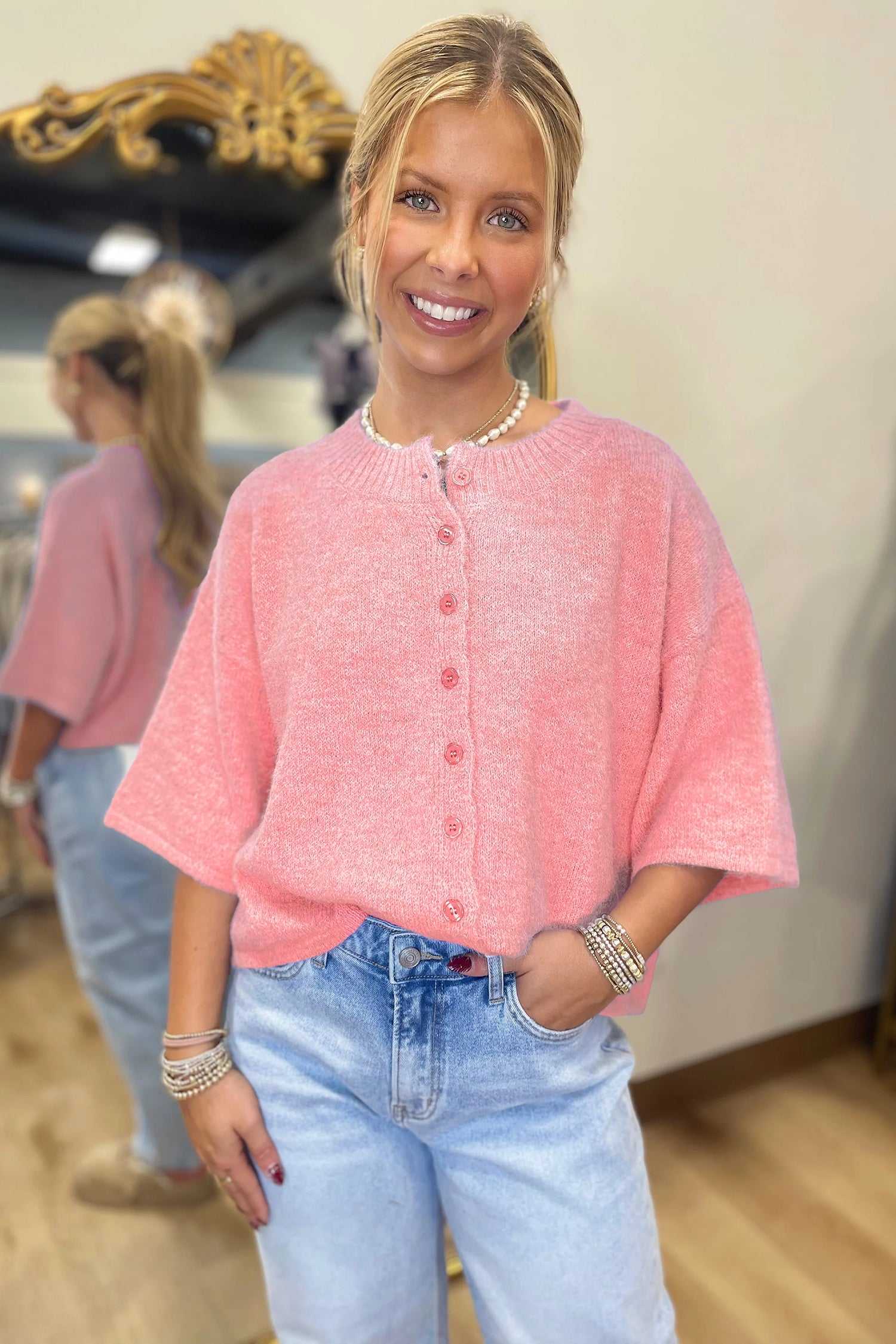 Fuzzy knit cardigan women in pastel peach with button-down front and 3/4 sleeves, styled for a casual chic look.