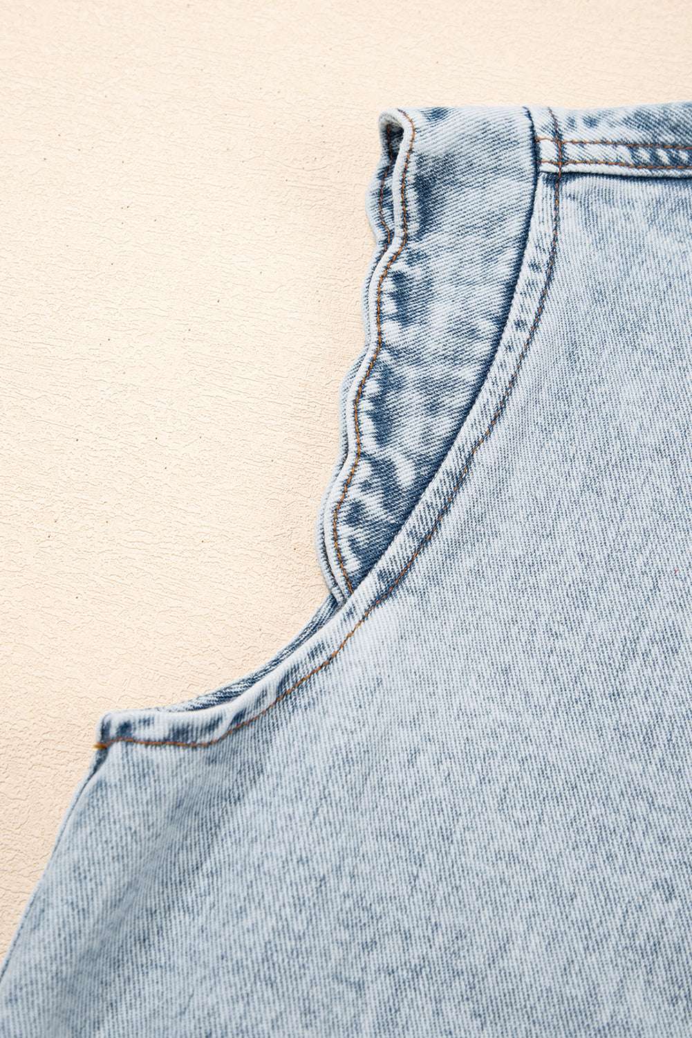 Detail of scalloped armhole trim on Beau Blue Denim Waistcoat, showcasing high-quality stitching and soft denim fabric.