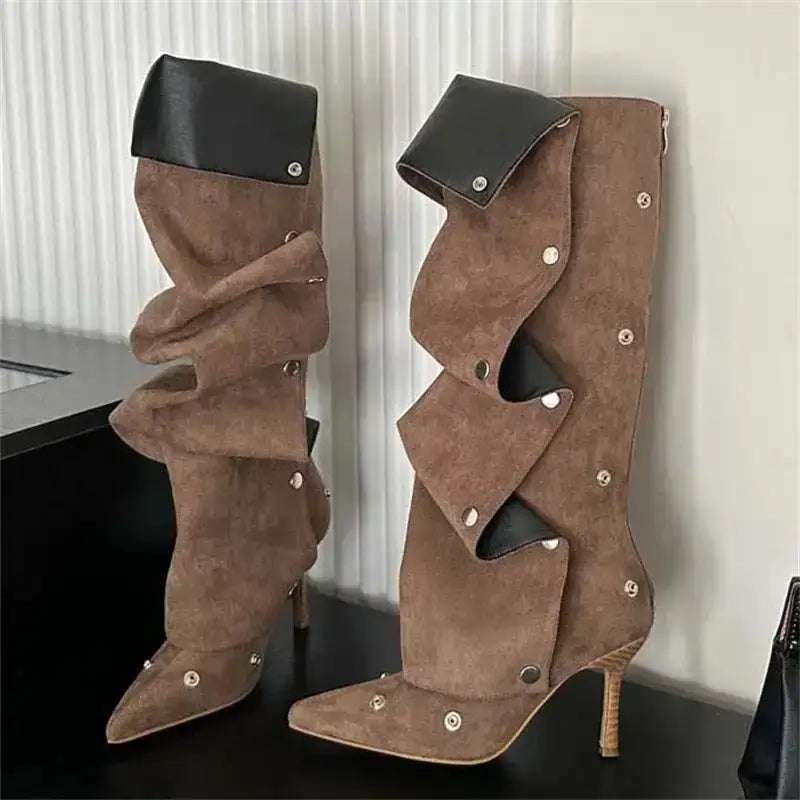 Women's brown suede knee high boots with pleated layers and thin heels, detailed with silver buttons and black inner lining.