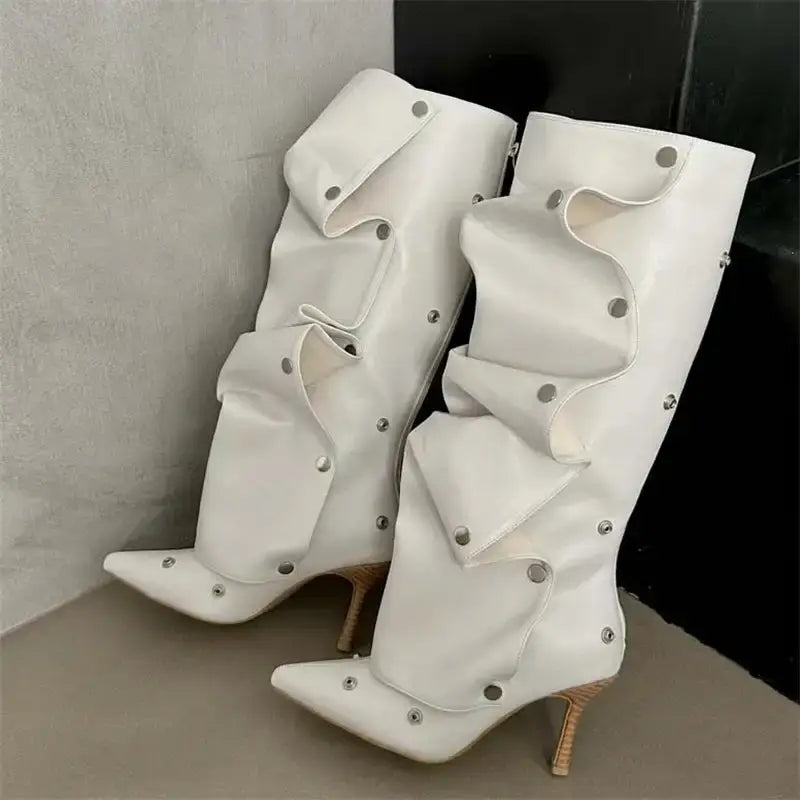 White knee high women's boots with pleated design, thin heels, and silver button embellishments, ideal for fashion-forward styling.