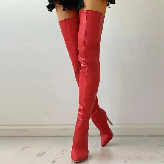 Women’s red over knee boots with sleek fit and high stiletto heel. Stylish and stretchy design for standout fashion appeal.
