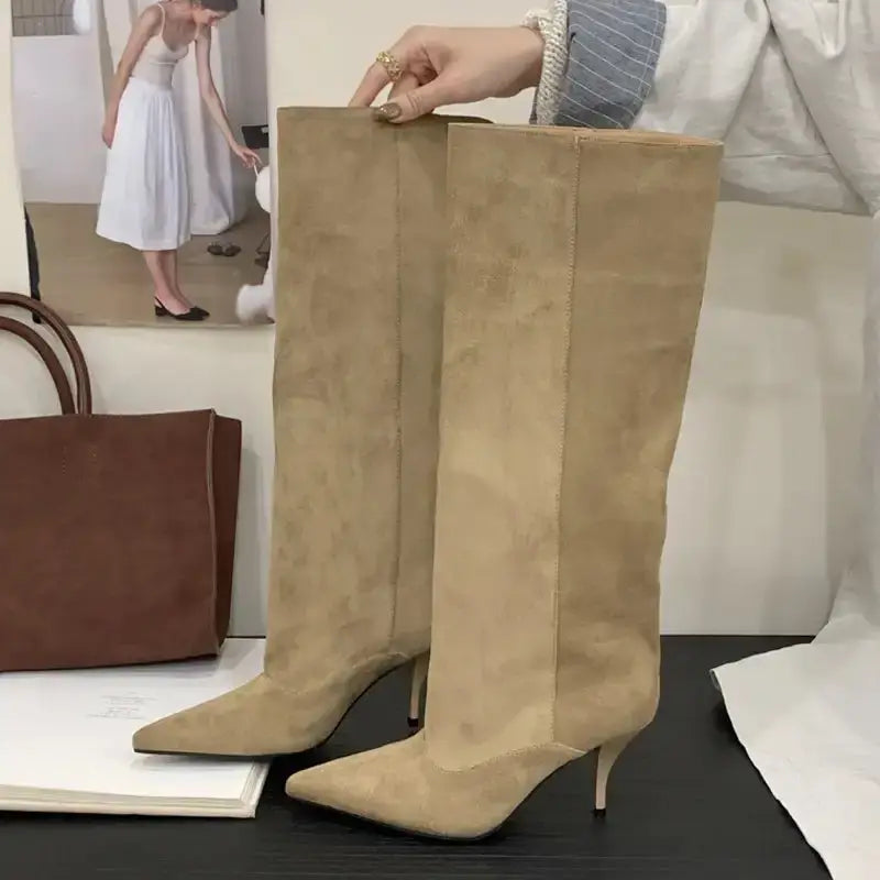 Stylish beige faux suede knee-high boots for women featuring a sleek kitten heel and elegant pointed toe design.