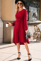 Model wearing the Red Long Sleeve Drape Midi Dress styled with black heels and accessories, showcasing a chic fall look.