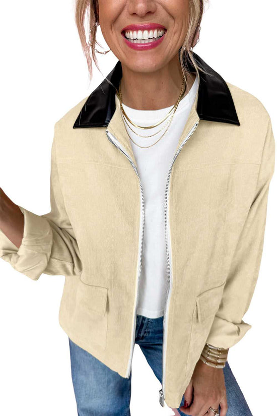 Cutout of smiling model in Leather Collar Corduroy Jacket, styled with rolled sleeves and layered necklaces for a trendy casual look.