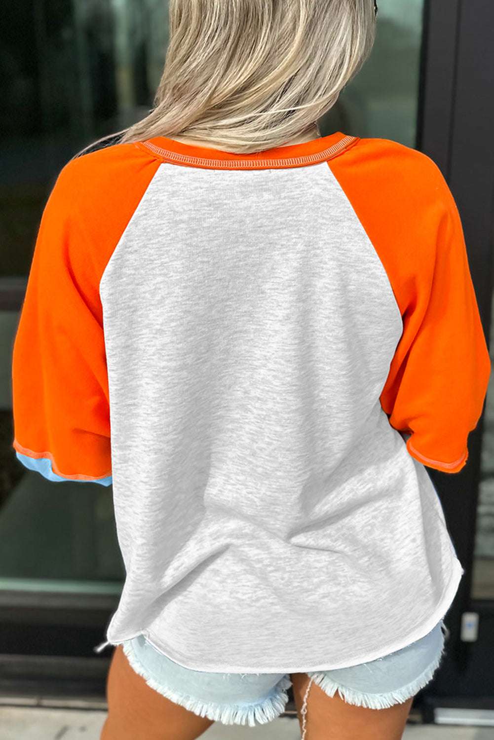 Back view of the Hello Pumpkin sweatshirt showing light grey body with vibrant orange raglan sleeves and blue cuffs, ideal for layering in autumn.