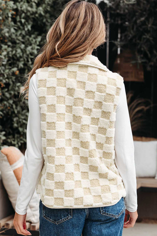 Person wearing a Sherpa Fleece Vest over a white shirt with a blurred background