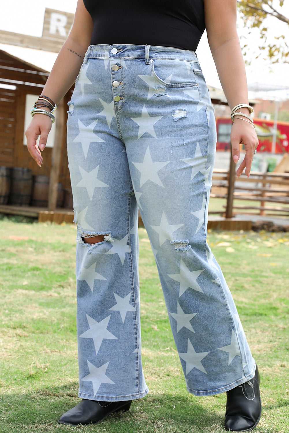 Front close-up of Fashionfitz star print distressed plus size jeans with ripped knees and button fly, perfect for summer wear.