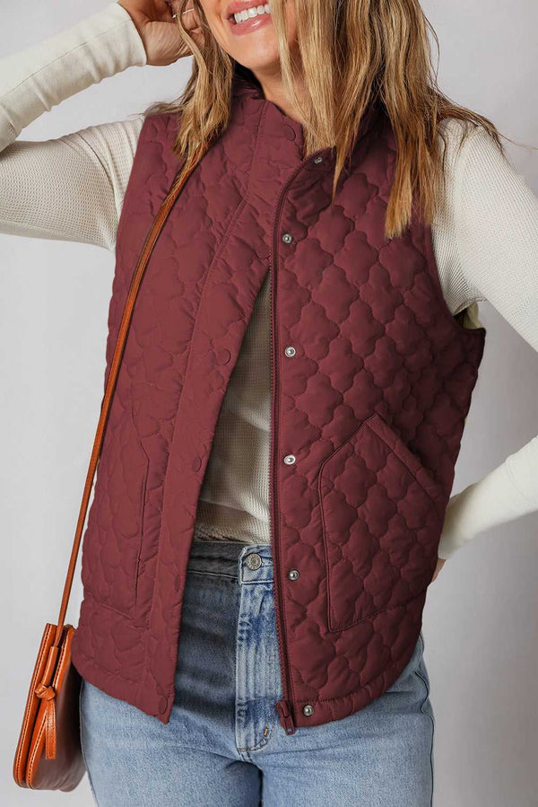 Flower‑Quilted Winter Gilet in burgundy with zip and snap buttons, styled with casual jeans and long-sleeve top for cozy winter layering.