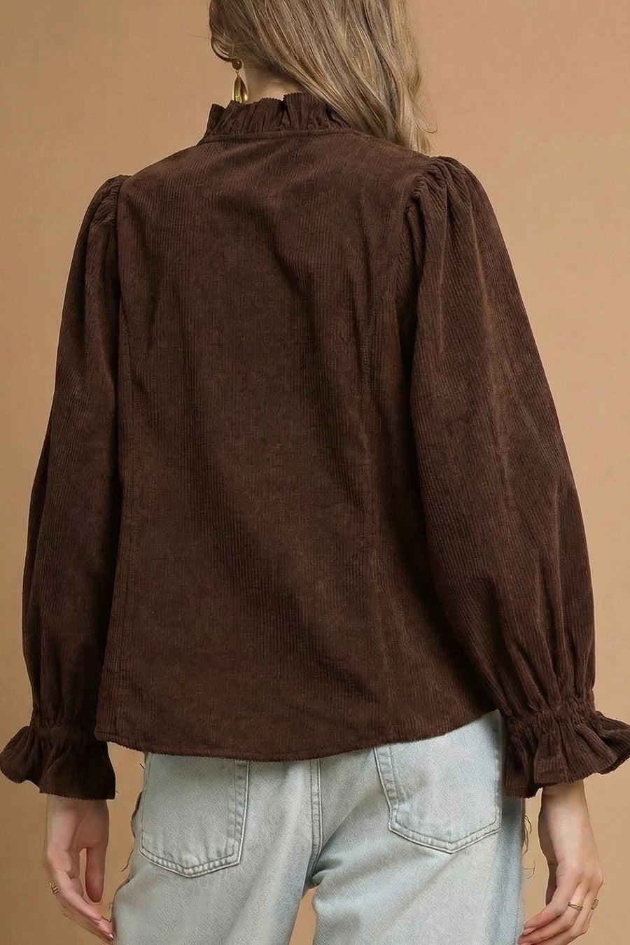 Detail of ruffle trim and V-neckline on corduroy shacket