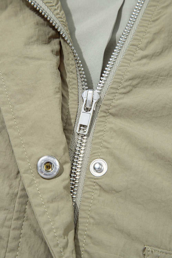 Detail of zipper and snap button closure on Cropped Hooded Utility Jacket, showcasing secure and stylish outerwear construction.