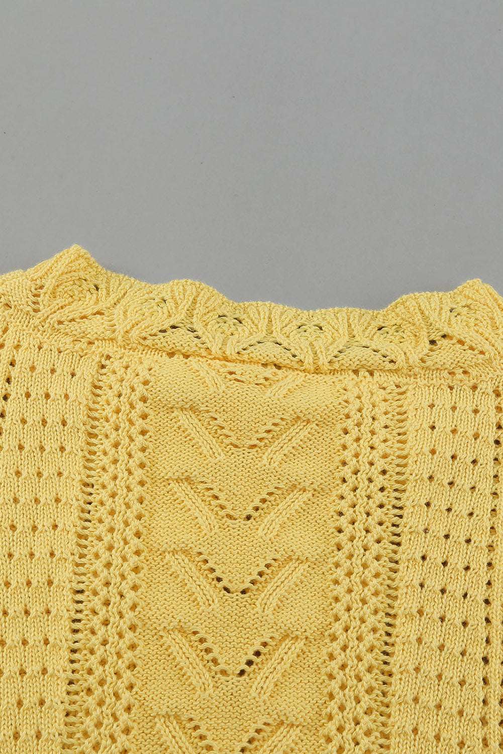 Neckline close-up of Yellow Crochet Lace Pointelle Knit Sweater, highlighting ribbed collar and fine pointelle knit pattern.