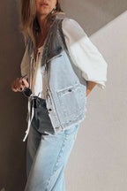 Side view of Beau Blue Denim Waistcoat with Frayed Edges styled with a white blouse and light denim jeans, accessorized with sunglasses.