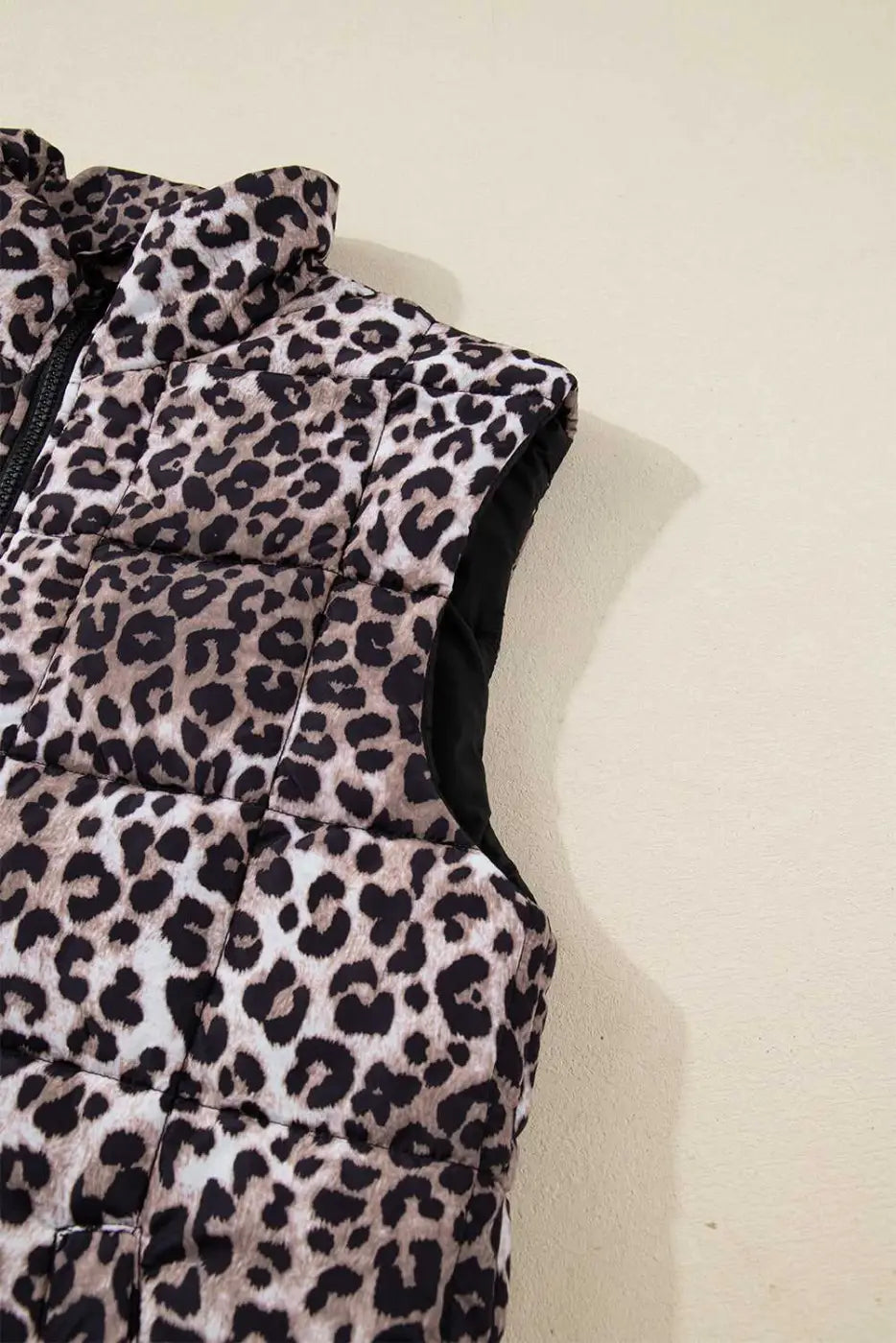 Sleeveless armhole detail of Leopard Print Quilted Puffer Gilet. Lightweight and padded for comfortable cold-weather wear.