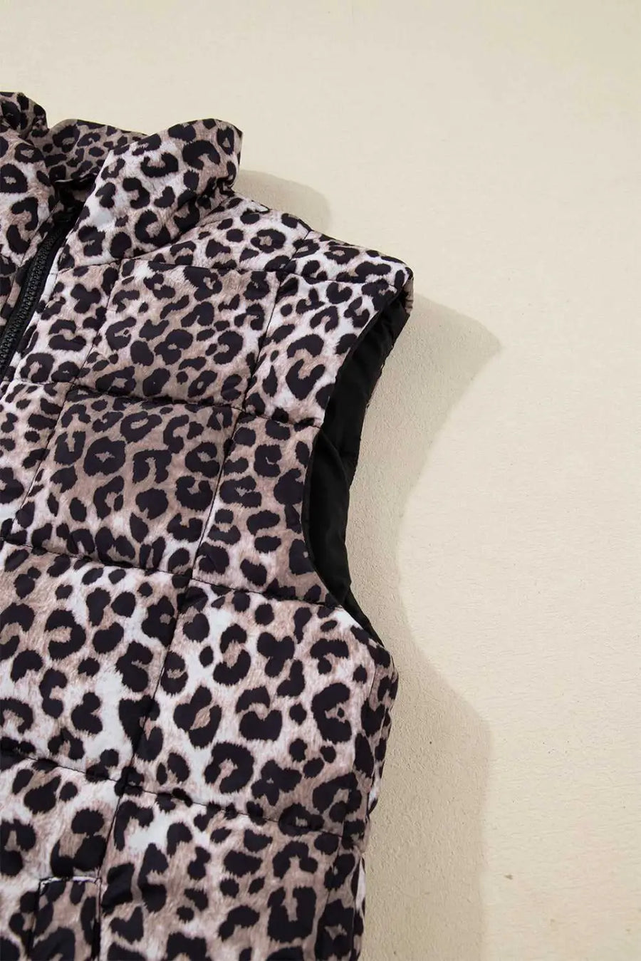 Sleeveless armhole detail of Leopard Print Quilted Puffer Gilet. Lightweight and padded for comfortable cold-weather wear.