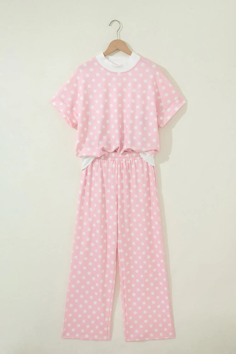 Women's polka dot mock neck top and pants flat lay casual