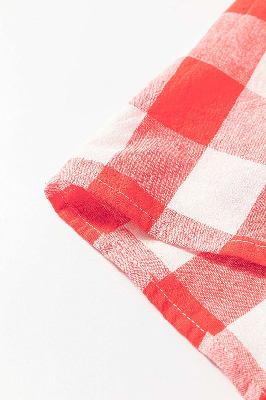 Close-up of red and white plaid fabric with stitched hem