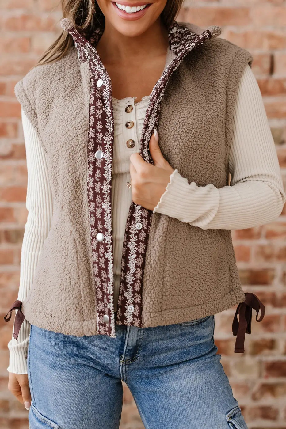 Women's Country Borg Fleece Gilet Winter Vest FashionFitz in khaki with sherpa texture, floral trim, and snap buttons styled with casual jeans.