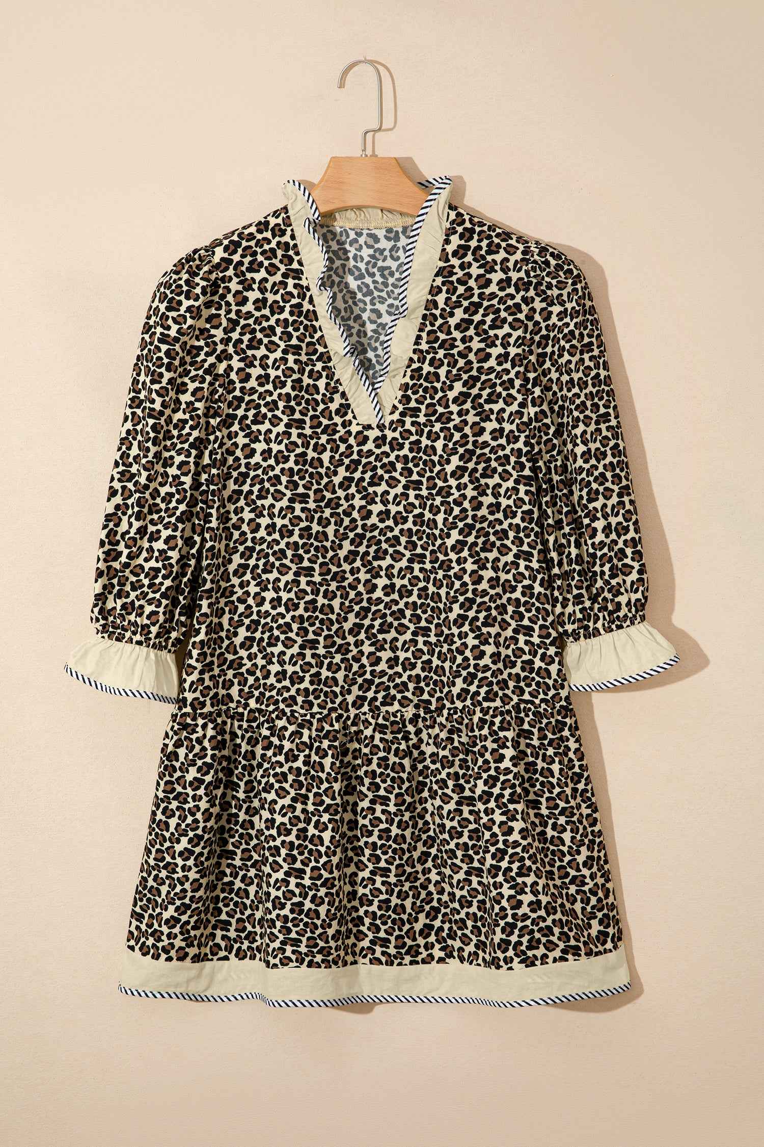 Leopard Print Striped Trim Mini Dress displayed on hanger, highlighting its A-line silhouette and contrast trim details for e-commerce display.