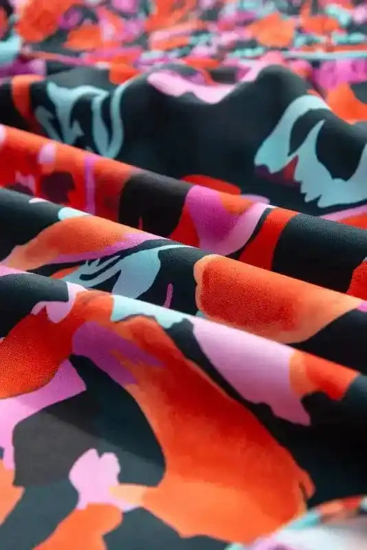 Fabric detail of Abstract Floral Shirred Puff Sleeve Blouse | FashionFitz, showing smooth texture and vivid red, pink, and teal floral print.