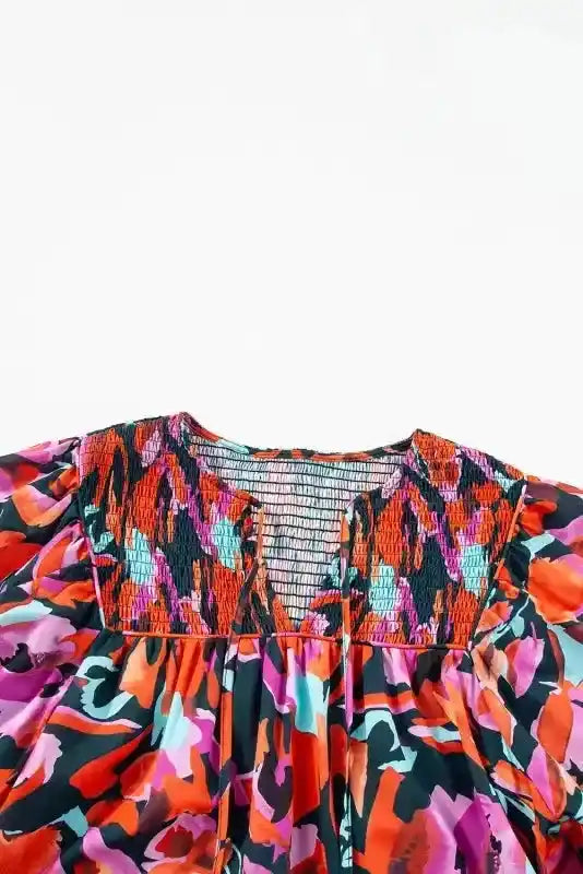 Close-up of shirred neckline on Abstract Floral Shirred Puff Sleeve Blouse | FashionFitz, featuring intricate smocking and bold abstract floral pattern.