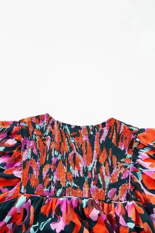 Back view of Abstract Floral Shirred Puff Sleeve Blouse | FashionFitz, highlighting the smocked panel and colorful abstract floral design.