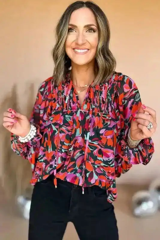 Close-up of model wearing Abstract Floral Shirred Puff Sleeve Blouse | FashionFitz, emphasizing the smocked neckline and vibrant floral print.