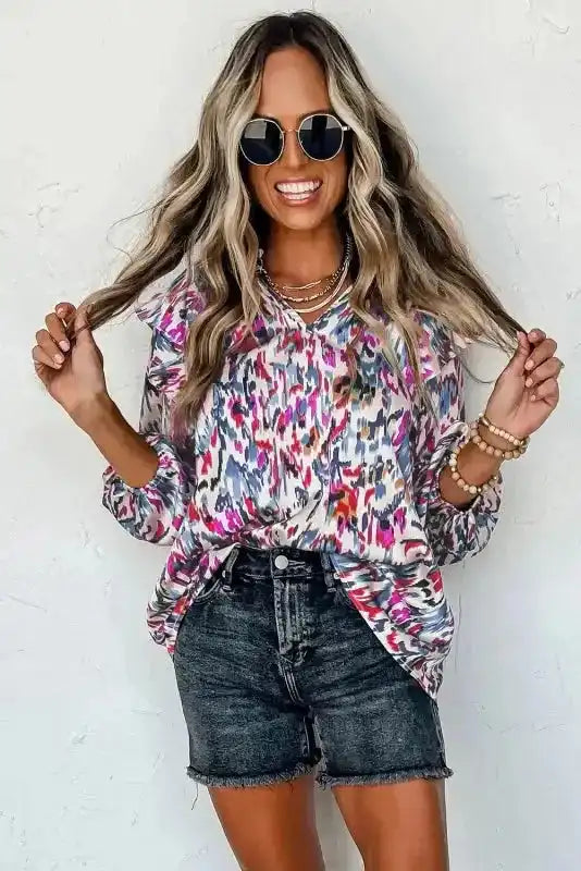 Model smiling in pink Abstract Ruffle Blouse with Puff Sleeves, styled for a casual summer outfit.