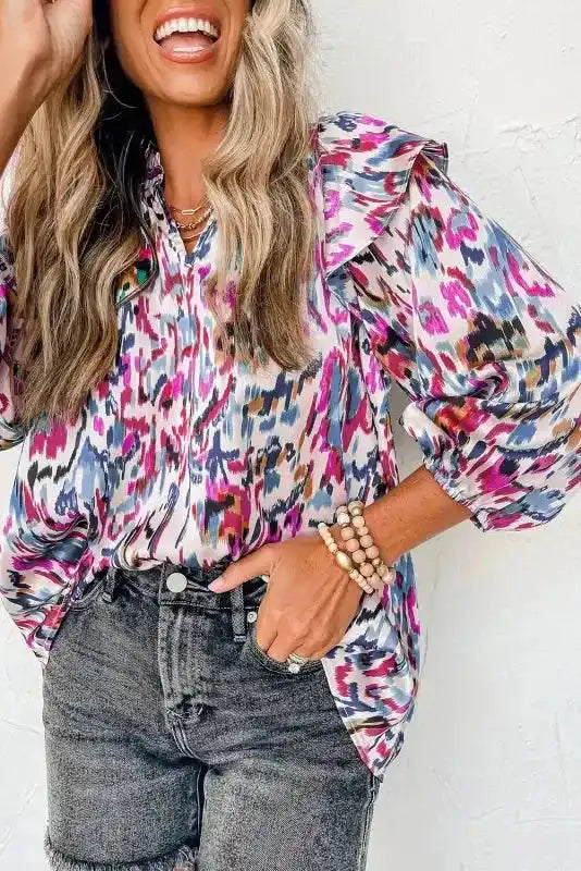 Model in pink Abstract Ruffle Blouse with Puff Sleeves and abstract print, styled with black denim shorts for a playful look.