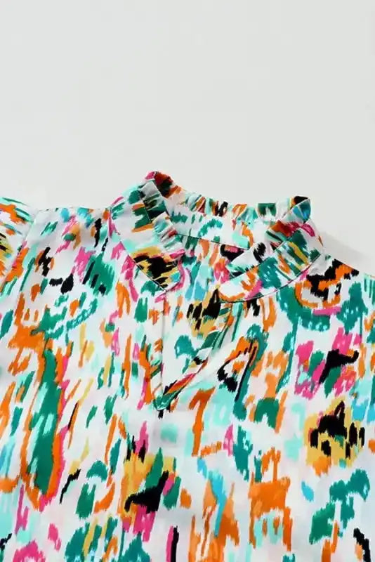 Close-up of V-neckline and ruffle collar on Abstract Ruffle Blouse with Puff Sleeves, highlighting unique design and stitching.