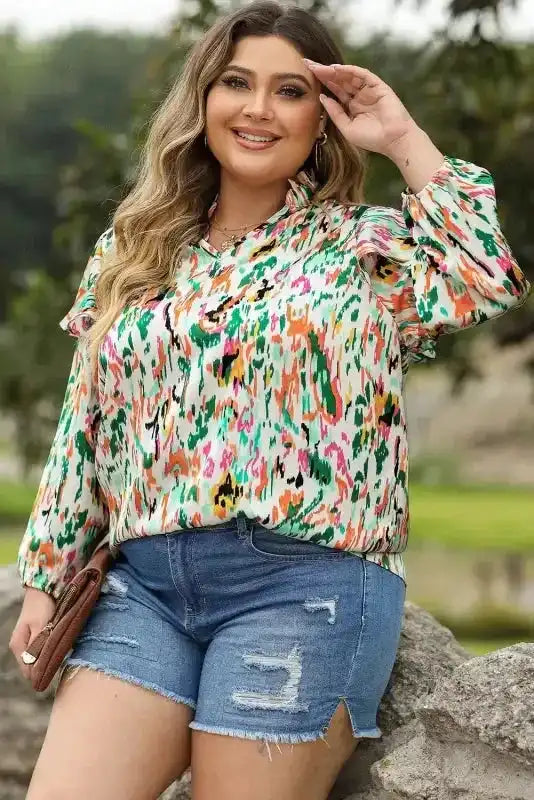 Model wearing Abstract Ruffle Blouse with Puff Sleeves and V Neck, paired with denim shorts for a casual yet stylish look.