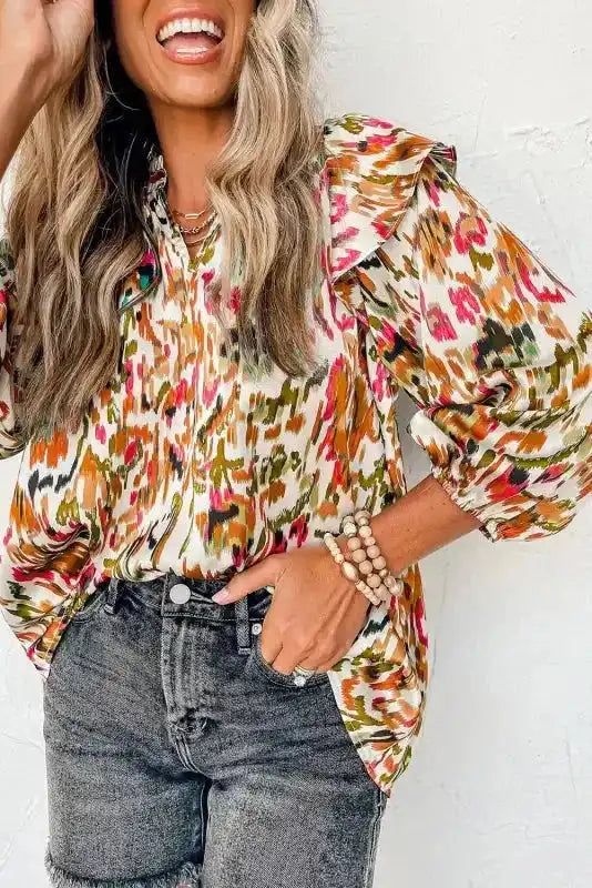 Abstract Ruffle Blouse with Puff Sleeves in multicolor print, styled with black denim shorts for a casual chic look.
