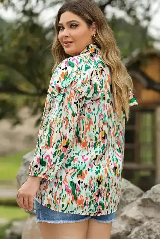 Back view of Abstract Ruffle Blouse with Puff Sleeves in multicolor floral print, showcasing unique ruffle detail and lightweight fabric.
