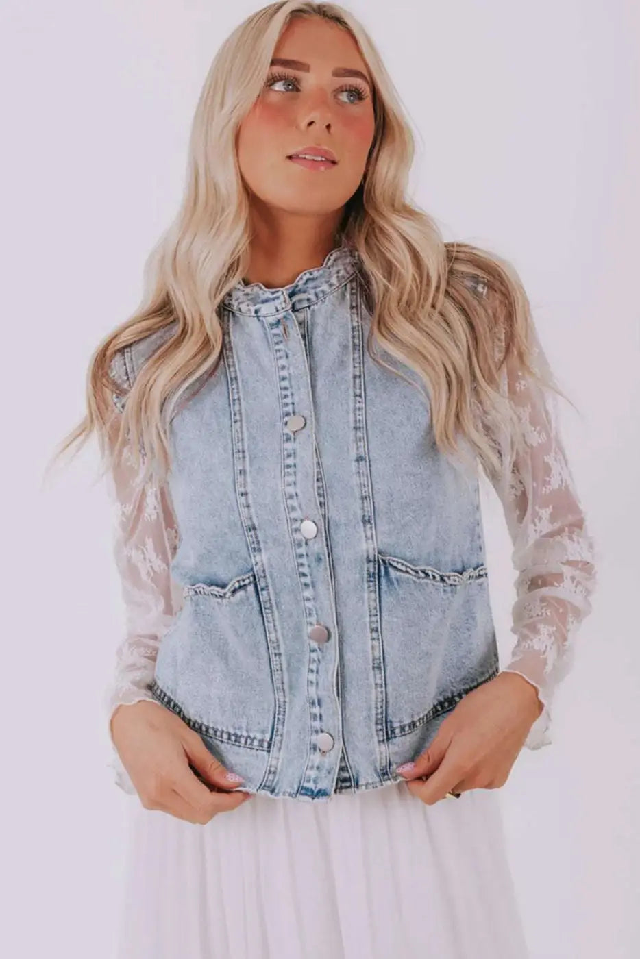 Model wearing Beau Blue Scallop‑Trim Denim Waistcoat paired with white dress, showcasing its casual and feminine gilet style.