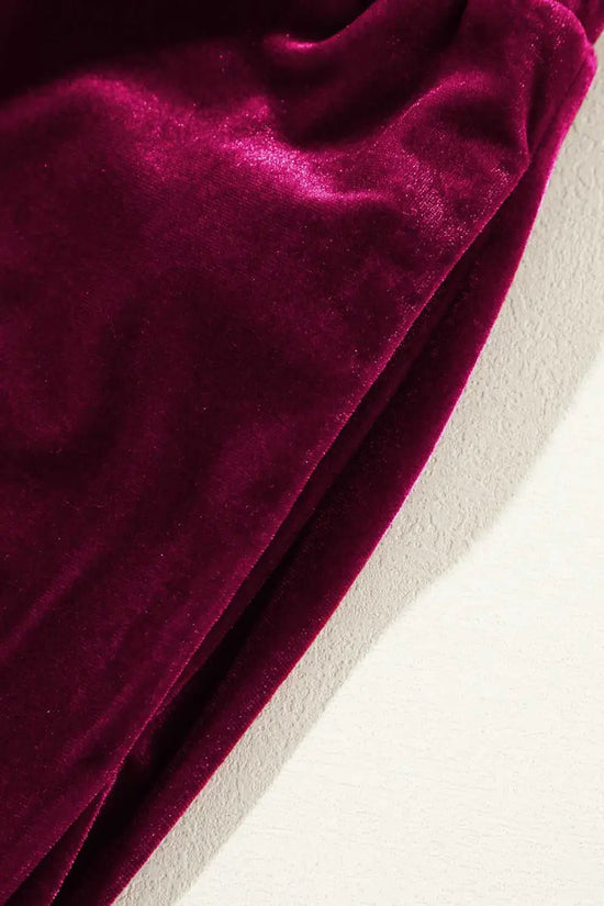 Detail of plush burgundy velvet fabric and side seam of yoga pants, emphasizing soft texture and premium finish for daily wear.