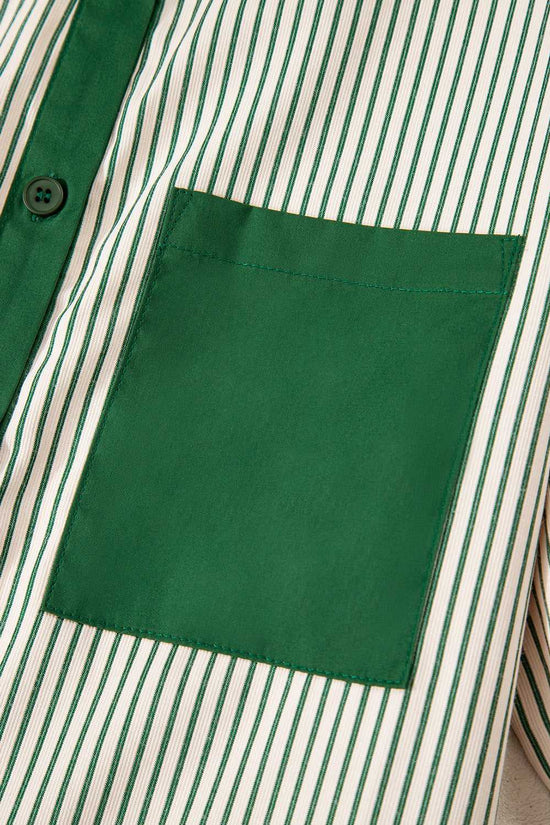 Detail of green pocket on striped mini dress, highlighting the modern monochrome design and casual summer style.