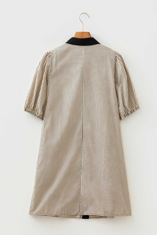 Back view of monochrome striped puff sleeve mini dress on hanger, highlighting relaxed fit and lightweight summer fabric.